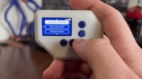 The PolyCast5 multitool device displaying its AI Packet Monitor function on a color screen.
