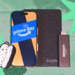 A person happily shopping online with a laptop, surrounded by various tech gadgets like headphones, a TV remote, and a smartwatch, symbolizing Prime Day deals.