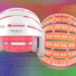 A person using a red-light therapy helmet for hair regrowth, illustrating modern hair restoration technology.