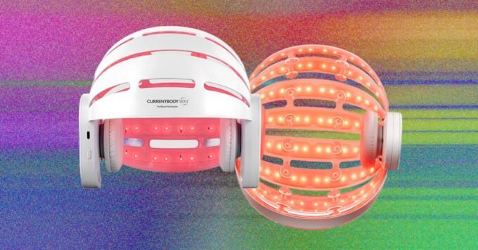 A person using a red-light therapy helmet for hair regrowth, illustrating modern hair restoration technology.