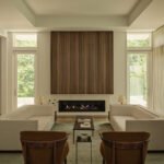 A beautifully designed living space by Sashya Thind, featuring a blend of global modernist furniture and warm textiles.