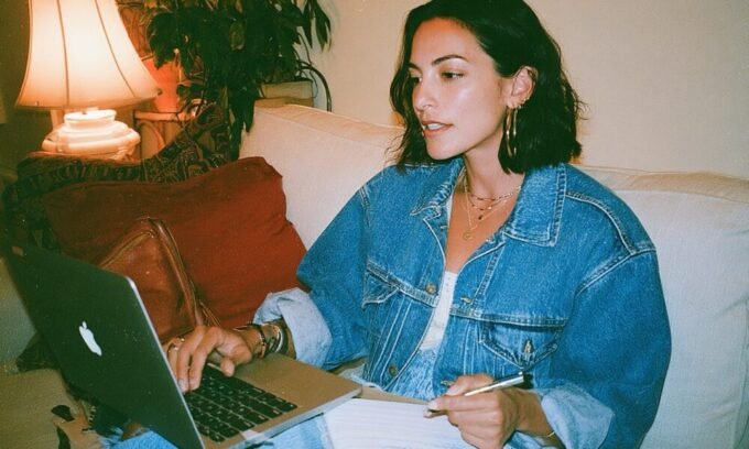 A person looking exhausted while juggling multiple tasks, symbolizing the burden of an unscalable coaching business.