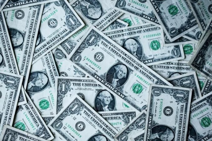 Digital dollar symbols flowing into traditional financial assets, representing stablecoins becoming productive capital.