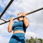 A person lifting weights, symbolizing strength and health, with a blurred background.