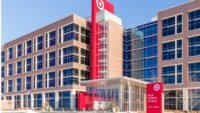 A person speaking on the phone, with a Target logo subtly in the background, representing customer service interaction.