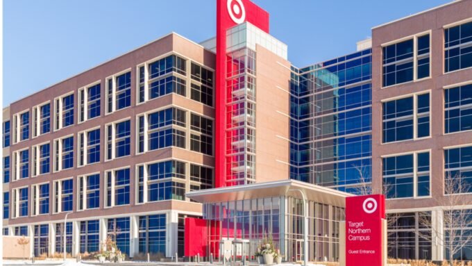 A person speaking on the phone, with a Target logo subtly in the background, representing customer service interaction.