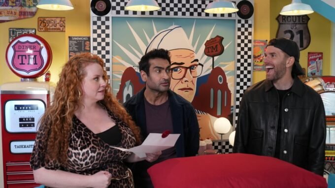 Taskmaster contestants Joel Dommett and Kumail Nanjiani in a cowboy costume, ready for a pillow fight.