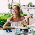 Woman holding a passport and healthy snacks, ready for travel, symbolizing good digestion on the go.