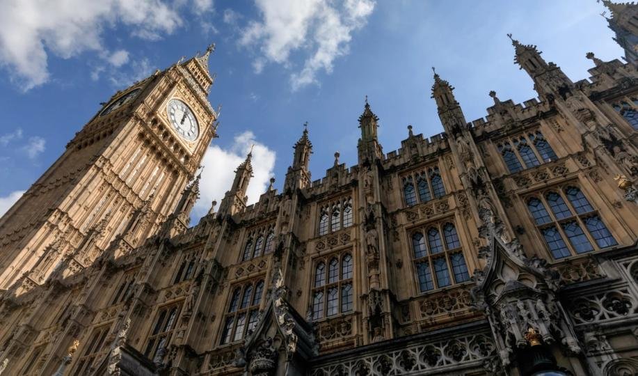 Houses of Parliament in London, representing UK legislative oversight on financial policy.