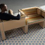 Armando Cabral's NKYINKYIM A CASA collection featuring a daybed and bookshelf with multi-directional striped fabrics.