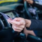 Illustration of a compromised driver's license with digital lock icon, symbolizing data breach and identity theft risk.