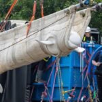 Four beluga whales being transported in slings and specialized containers during their rescue mission to Chicago.