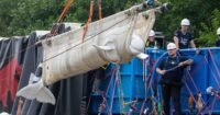 Four beluga whales being transported in slings and specialized containers during their rescue mission to Chicago.