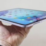 A selection of Apple iPad models, including iPad Air, iPad Pro, and iPad Mini, on a modern desk.