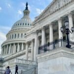 A gavel rests on a desk in front of a blurred image of the U.S. Capitol building, symbolizing legislative action and the delay of the Crypto Clarity Act.
