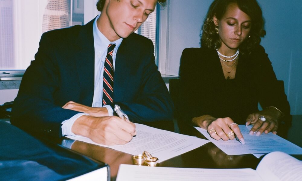 Navigating Divorce: 10 Critical Questions to Ask Before You Begin 3 A couple's hands pulling apart a wedding ring, symbolizing divorce and separation.