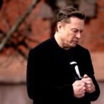 Elon Musk looking serious, representing the legal scrutiny he faces.