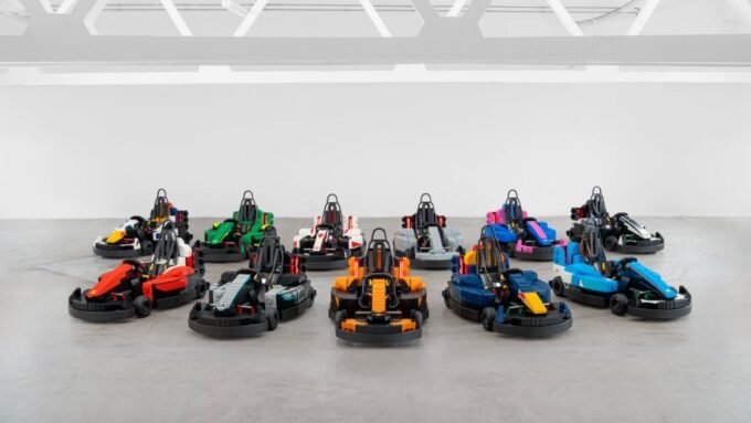Formula 1 drivers in custom-built, drivable Lego minicars on the Silverstone track during the British Grand Prix Drivers' Parade.