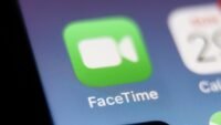 Illustration of a person receiving a suspicious FaceTime call from 'Apple Support' with a warning icon.