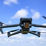 FCC Moves to Ground Rebranded DJI Drones Amid National Security Concerns 8 A drone flying over a cityscape with the FCC logo superimposed, representing the ban on DJI rebranded products.