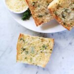 The Ultimate 15-Minute Garlic Toast: A Recipe for Instant Flavor 8 Crispy golden garlic toast slices on a baking sheet, garnished with fresh parsley.
