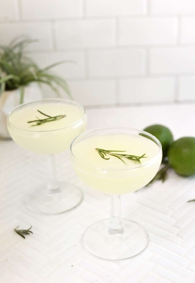 A perfectly chilled Classic Gimlet cocktail in a coupe glass, garnished with a lime wedge.