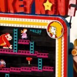 Lego Donkey Kong arcade machine set, showing Jumpman figure, joystick, and barrels rolling down tracks.