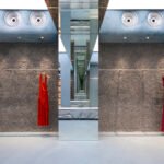 Interior view of Lady Pipa's Madrid flagship store with blue resin floor, limewashed walls, and mirrored arches, evoking a David Lynch film set.