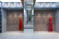 Interior view of Lady Pipa's Madrid flagship store with blue resin floor, limewashed walls, and mirrored arches, evoking a David Lynch film set.