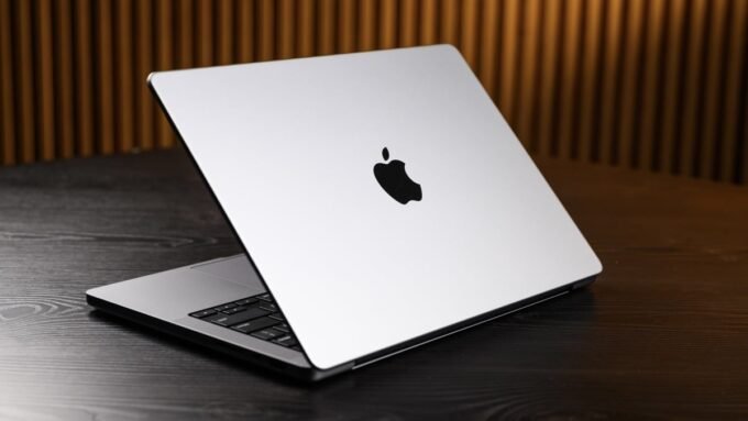 Urgent Mac Alert: 'Crash Report' Malware Targets Your Digital Life 9 A stylized image of a Mac laptop screen displaying a fake 'Crash Report' prompt with a malicious overlay, symbolizing the CrashStealer malware threat.