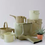Martha Stewart with her farm hens, showcasing Hachiman's new olive and sage colored multi-purpose bucket and watering can.