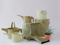 Martha Stewart with her farm hens, showcasing Hachiman's new olive and sage colored multi-purpose bucket and watering can.