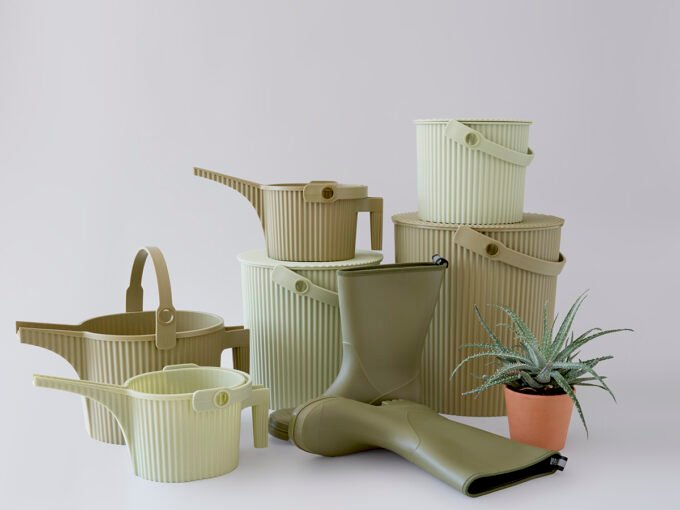 Martha Stewart with her farm hens, showcasing Hachiman's new olive and sage colored multi-purpose bucket and watering can.