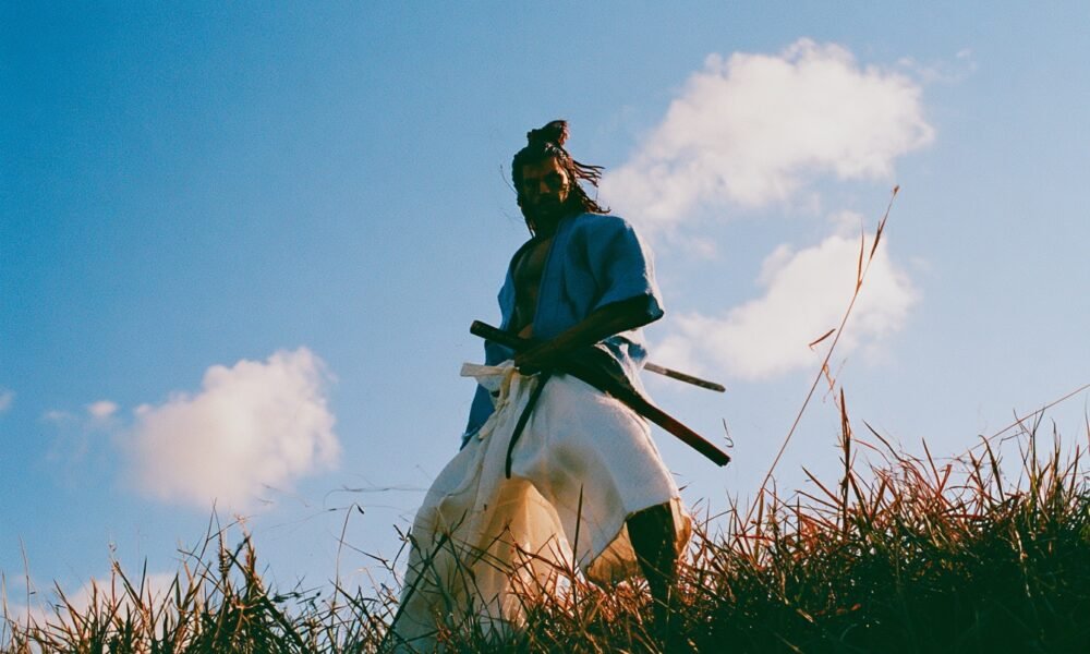 A person meditating with a samurai sword in the background, symbolizing modern discipline and ancient wisdom.