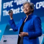 AMD CEO Lisa Su speaking at the Advancing AI conference, with a graphic related to AI technology in the background.
