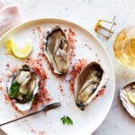 Close-up of fresh oysters on a bed of ice, symbolizing their potential health benefits for gut inflammation.