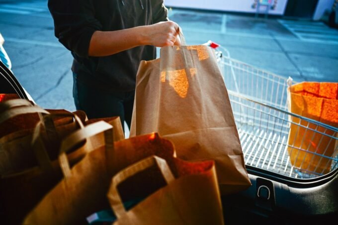 A collection of paper shopping bags, questioning their environmental impact
