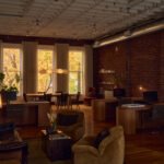 The Evolving Canvas: Pat Austin's Portland Studio Redefines Design Philosophy 8 Interior of Pat Austin's Portland studio, showcasing custom maple desks, vintage furniture, and a residential-style lounge within the Historic Cully Building.