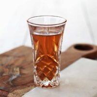 A perfectly crafted Peanut Butter and Jelly Shot in a shot glass, garnished with a tiny PB&J sandwich.