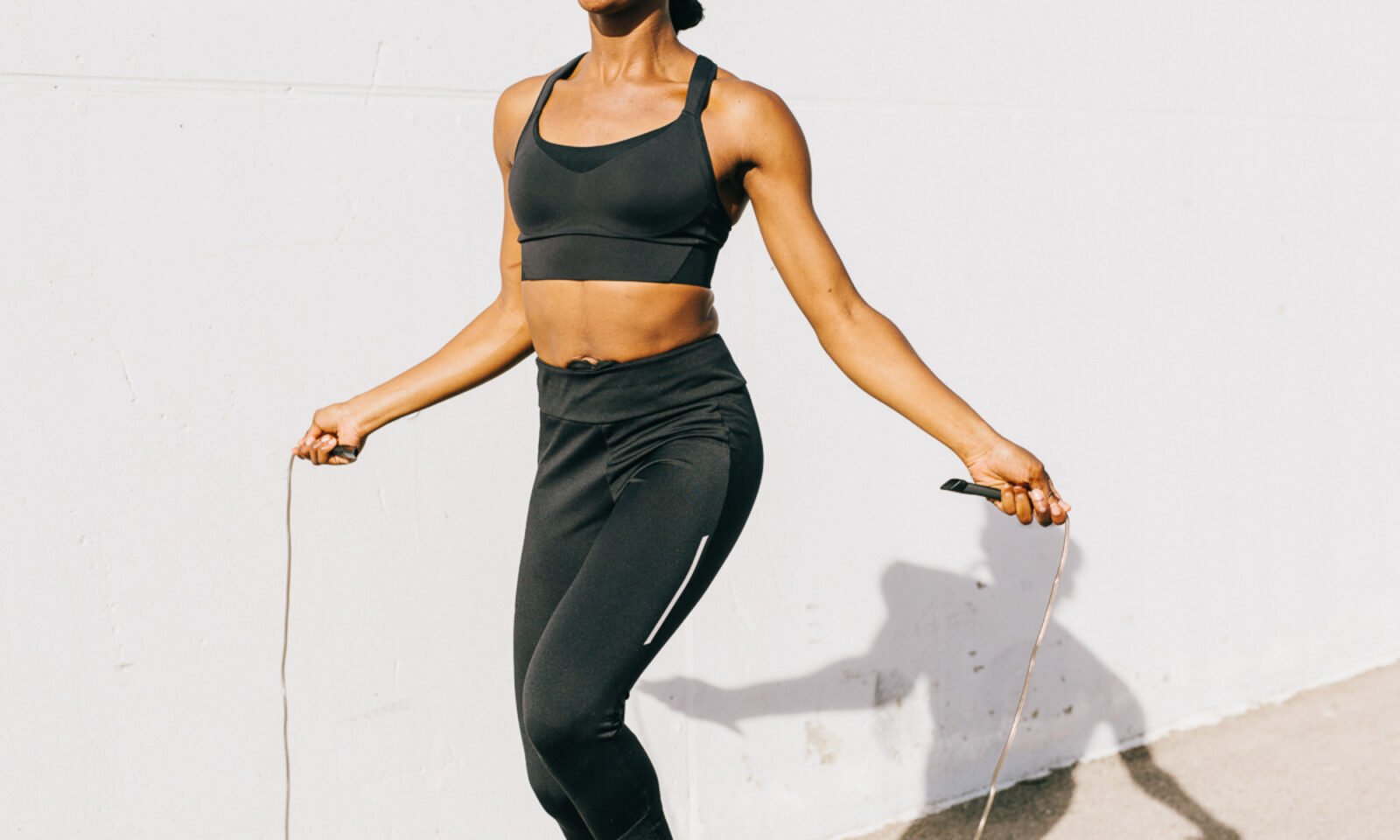Person performing vigorous exercise, symbolizing strength and health, against the backdrop of scientific research on rheumatoid arthritis prevention.