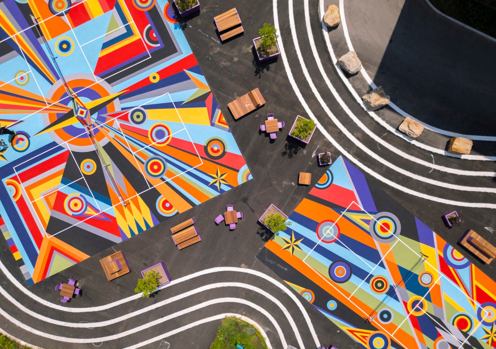 Overhead view of Sharmistha Ray's 'Geometry of Play' pickleball courts at Arts Landing in Pittsburgh, featuring colorful geometric patterns with players on the court.