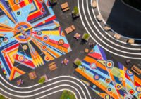 Overhead view of Sharmistha Ray's 'Geometry of Play' pickleball courts at Arts Landing in Pittsburgh, featuring colorful geometric patterns with players on the court.