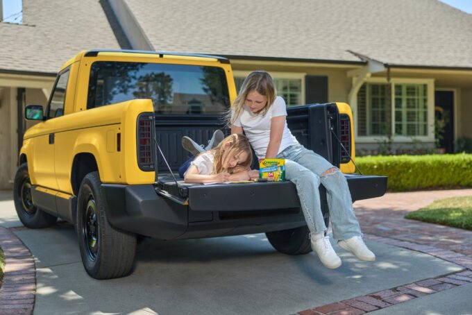 A Slate Truck wrapped in a vibrant Crayola Dandelion color, showcasing its customizable design.