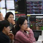 South Korea's Rollercoaster Market: AI Fuels Record Swings and Unpredictable Futures 8 Currency dealers monitor exchange rates in a foreign exchange dealing room at Hana Bank headquarters in Seoul, amidst South Korea's volatile Kospi market.