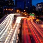 Cars on a highway, with a speedometer highlighting the minimal time saved versus fuel consumed by speeding.