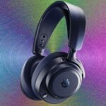SteelSeries Arctis Nova Pro Omni gaming headset with its USB hub on a desk.