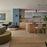A beautifully designed living space in a Toronto Net Zero Ready Home, featuring a double-sided sofa, natural materials, and warm lighting, showcasing sustainable luxury.