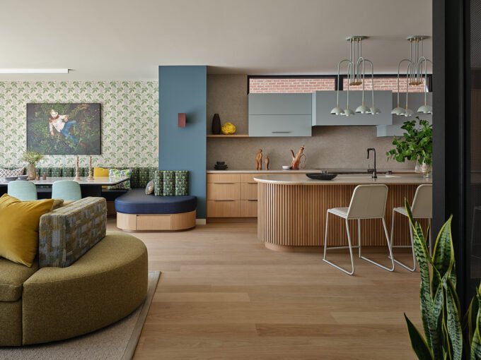 A beautifully designed living space in a Toronto Net Zero Ready Home, featuring a double-sided sofa, natural materials, and warm lighting, showcasing sustainable luxury.