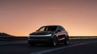 A Tesla vehicle operating as a robotaxi on a street in Miami, showcasing autonomous driving technology.