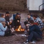 A family enjoying outdoor activities together at a scenic U.S. summer camp, with kids and adults participating in fun adventures.